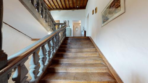 a staircase in a house with wooden floors at Château Porthos Tranquillité des Pyrénées in Lanne en Barétous