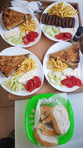 four plates of food on a table with different foods at PROKLETIJE eko katun Vusanje in Gusinje