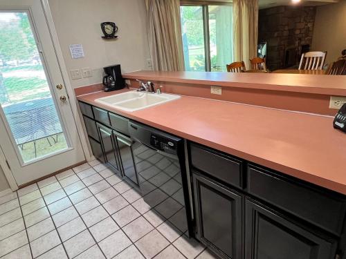 a kitchen with a sink and a counter at Golfside Vacation Home 2 in Bella Vista