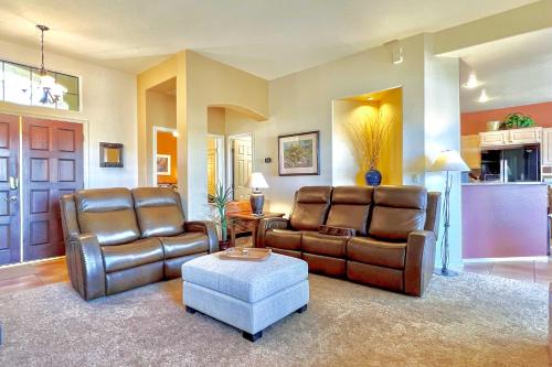 a living room with two leather chairs and a table at Oro Valley Getaway with Patio, BBQ and Mountain Views! in Oro Valley
