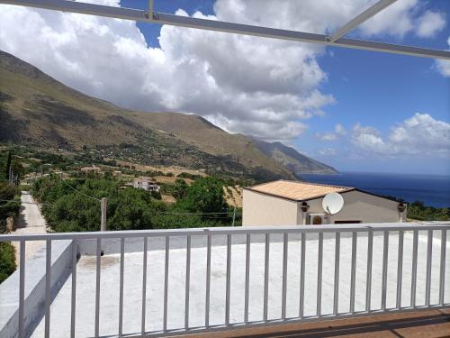 a view of the ocean from the balcony of a house at La casetta a Scopello in Scopello