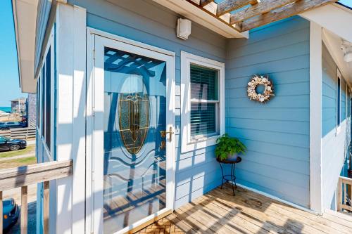 a blue house with a front door with a wreath at Holiday House in Buxton