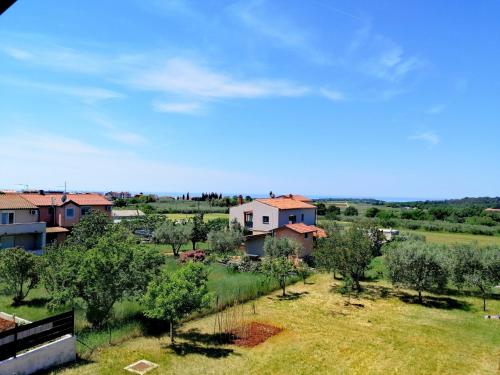 a view of a village with houses and trees at 7 PALMI Novigrad in Novigrad Istria