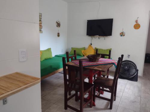 a dining room with a table and a couch at Cabañas Esferas de Cristal in Capilla del Monte