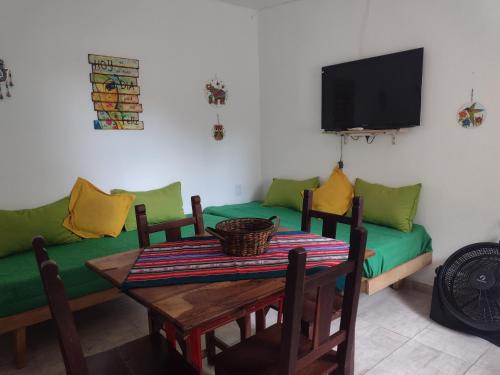 a living room with a table and a couch at Cabañas Esferas de Cristal in Capilla del Monte
