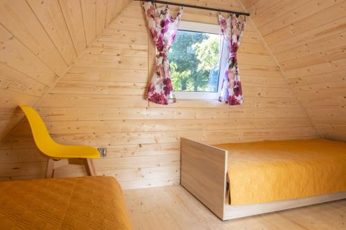 ein Schlafzimmer mit einem Bett und einem Fenster in einem Zimmer in der Unterkunft Domek in Szklarska Poręba