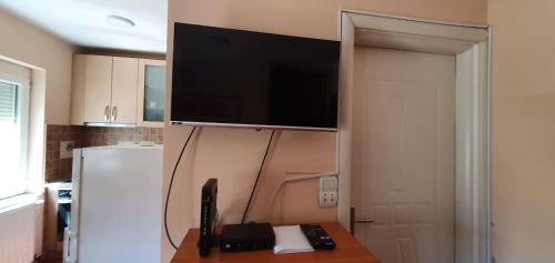 a flat screen tv on a wall in a kitchen at Julija 2 in Pančevo