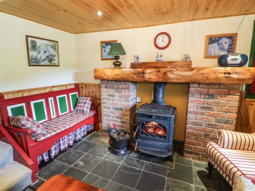 a living room with a fireplace and a stove at Ceol Na N'ean in Sneem