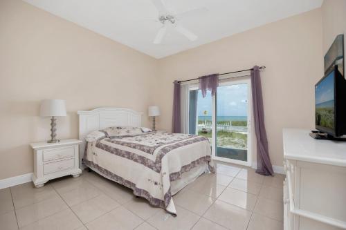 a bedroom with a bed and a large window at Wave Runner, 4 Bedrooms, Sleeps 10, Ocean Front, WiFi in Flagler Beach