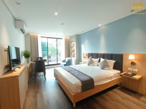 a hotel room with a bed and a television at Hồng Gia Tuệ Lake View in Hanoi