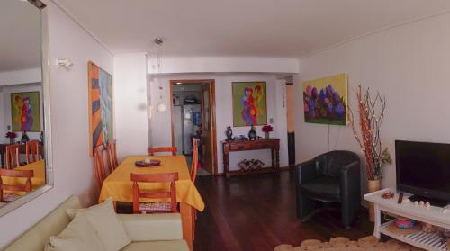 a living room with a couch and a table at Depto playa amarilla ConCon in Concón
