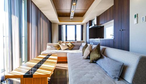 a living room with a couch and some windows at Miru Nozomi Views in Niseko