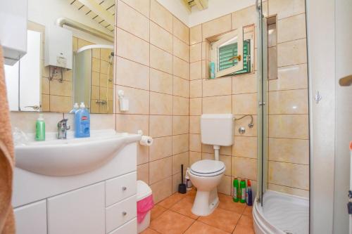 a bathroom with a toilet and a sink and a shower at House Dream Bay in Sali