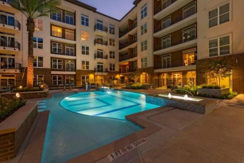a swimming pool in front of a apartment building at Luxury Apartment with KING BED and POOL and FREE PARKING 4 in Houston
