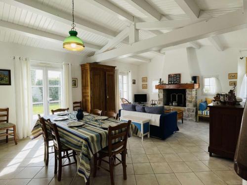 un salon avec une table et un canapé dans l'établissement Maison 5 pièces avec jardin clos, terrasse, à proximité de la plage et du centre, 8 couchages - FR-1-224B-157, à Noirmoutier-en-l'lle