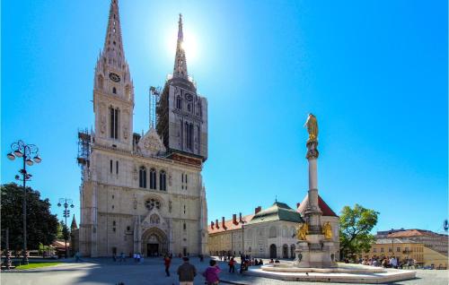 a large cathedral with a statue in front of it at Beautiful Home In Klostar Ivanic in Kloštar Ivanić
