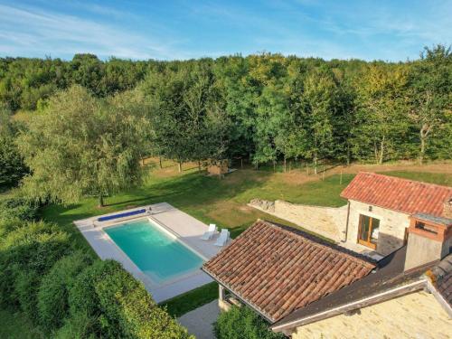 an aerial view of a house with a swimming pool at Cosy cottage in St Medard D'excideuil with pool in Laurière