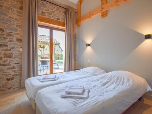 a bedroom with a bed with towels on it at Cosy cottage in St Medard D'excideuil with pool in Laurière