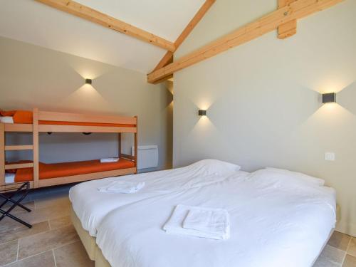a bedroom with a white bed and a bunk bed at Cosy cottage in St Medard D'excideuil with pool in Laurière