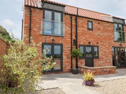 an exterior view of a brick house with black windows at The Old Doghouse in York