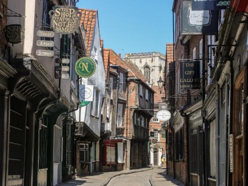 an alley with buildings and signs on the side of a street at The Old Doghouse in York