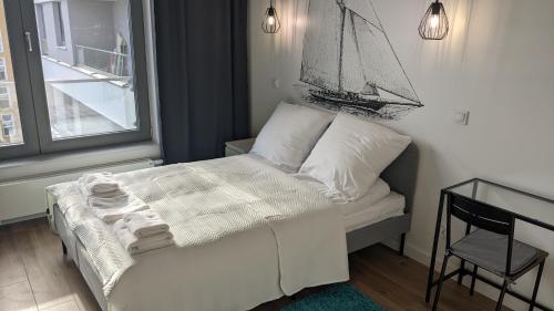 a bedroom with a bed with a sail on the wall at Plac Unii: Rybka Premium in Gdynia