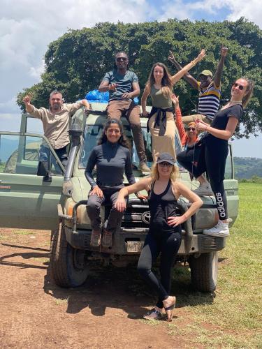 a group of people sitting on the back of a truck at Mazzola Safari House & Backpacking in Arusha
