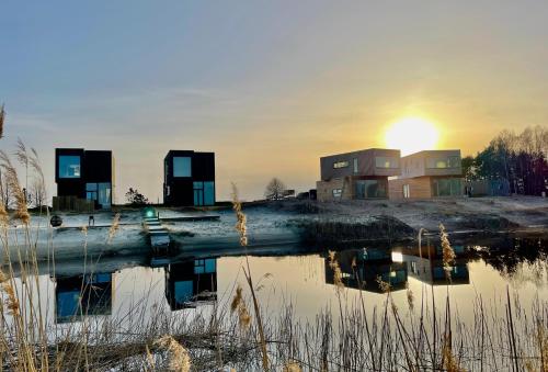 a house on the shore of a body of water at Jaukūs ART stiliaus apartamentai antrame aukšte su vaizdu į marias in Svenele