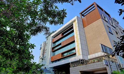 a tall building with a blue sky in the background at Treebo Trend Lazystay Grand Patia in Bhubaneshwar