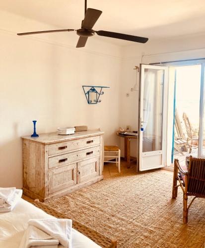 a bedroom with a dresser and a sliding glass door at Hôtel Lido Beach in Hyères