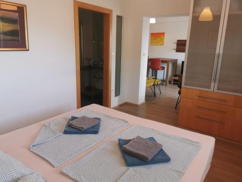 a bedroom with two towels sitting on a bed at BC Bikers Welcome Apartments in Senj