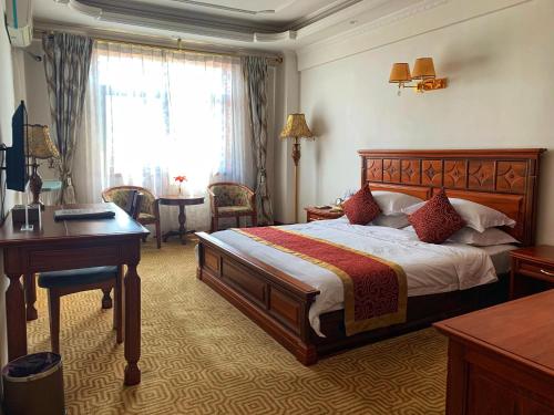 a hotel room with a bed and a desk and a desk at Asia & Africa Hôtel in Antananarivo