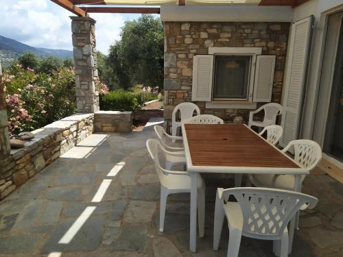 a wooden table and chairs on a patio at Ambra in Astris