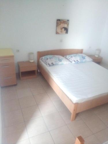 a bedroom with a bed and a dresser and a bed at Zdenka javoran in Zubovići
