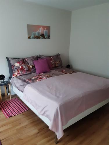 a bed in a room with a white wall at Ferienhaus Inge in Kirchberg an der Raab