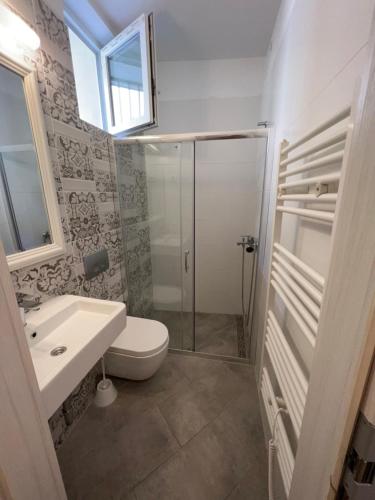 a bathroom with a shower and a toilet and a sink at OLD COURT KOPER in Koper