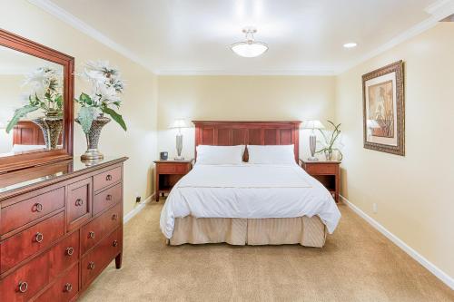 a bedroom with a bed and a dresser and a mirror at Silverado Resort and Spa II in Napa