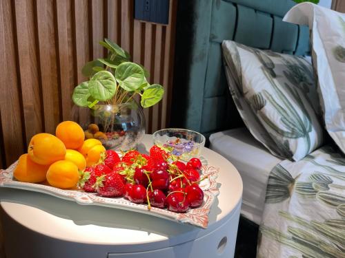 a tray of fruit on a table next to a bed at Relais Dea Degli Ulivi in Agrigento