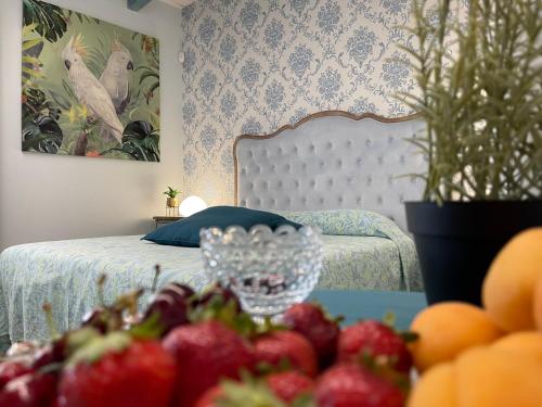a bedroom with a bed and a bowl of fruit on a table at Relais Dea Degli Ulivi in Agrigento