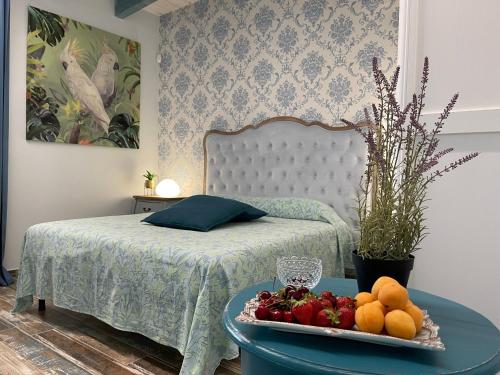 a bedroom with a bed with a tray of fruit on a table at Relais Dea Degli Ulivi in Agrigento