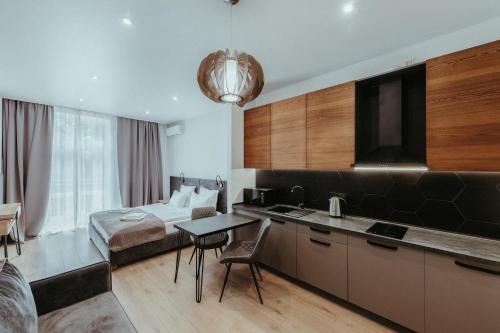 a hotel room with a kitchen and a bed at Apartel Shayan in Shaian