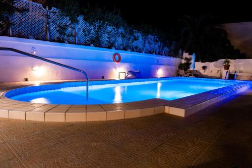 a swimming pool at night with lights on it at D View 4 You in Mellieħa