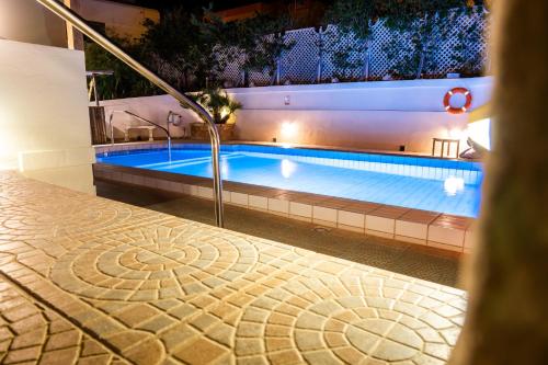 a swimming pool at night with a lit up swimming pooliterator at D View 4 You in Mellieħa