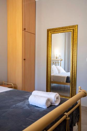 a bedroom with a mirror with a bed and a mirror at Five Stars Villa in Skala Kefalonias
