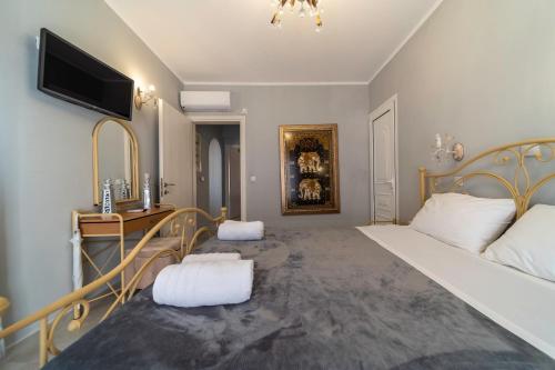 a bedroom with a bed and a tv on the wall at Five Stars Villa in Skala Kefalonias