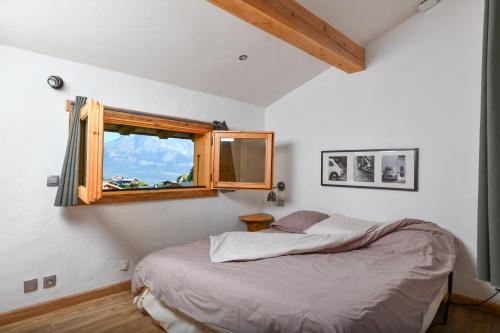 um quarto com uma cama e uma janela em Vielyterra - Chalet haut de gamme - Domaine du mont blanc em Saint-Gervais-les-Bains