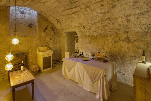 a large room with a table in a stone building at Borgo Incantato Spoleto in Pompagnano