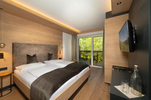 Postel nebo postele na pokoji v ubytování Hotel Alpina