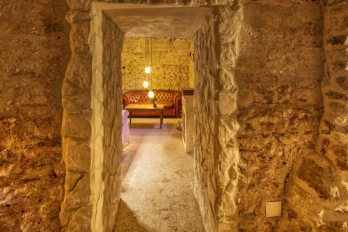 a hallway in a cave with a couch in the distance at Borgo Incantato Spoleto in Pompagnano