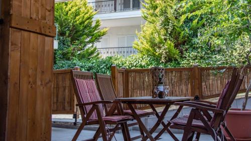 a table and two chairs on a patio at Casa Mameli Αpartments in Kallithea Halkidikis